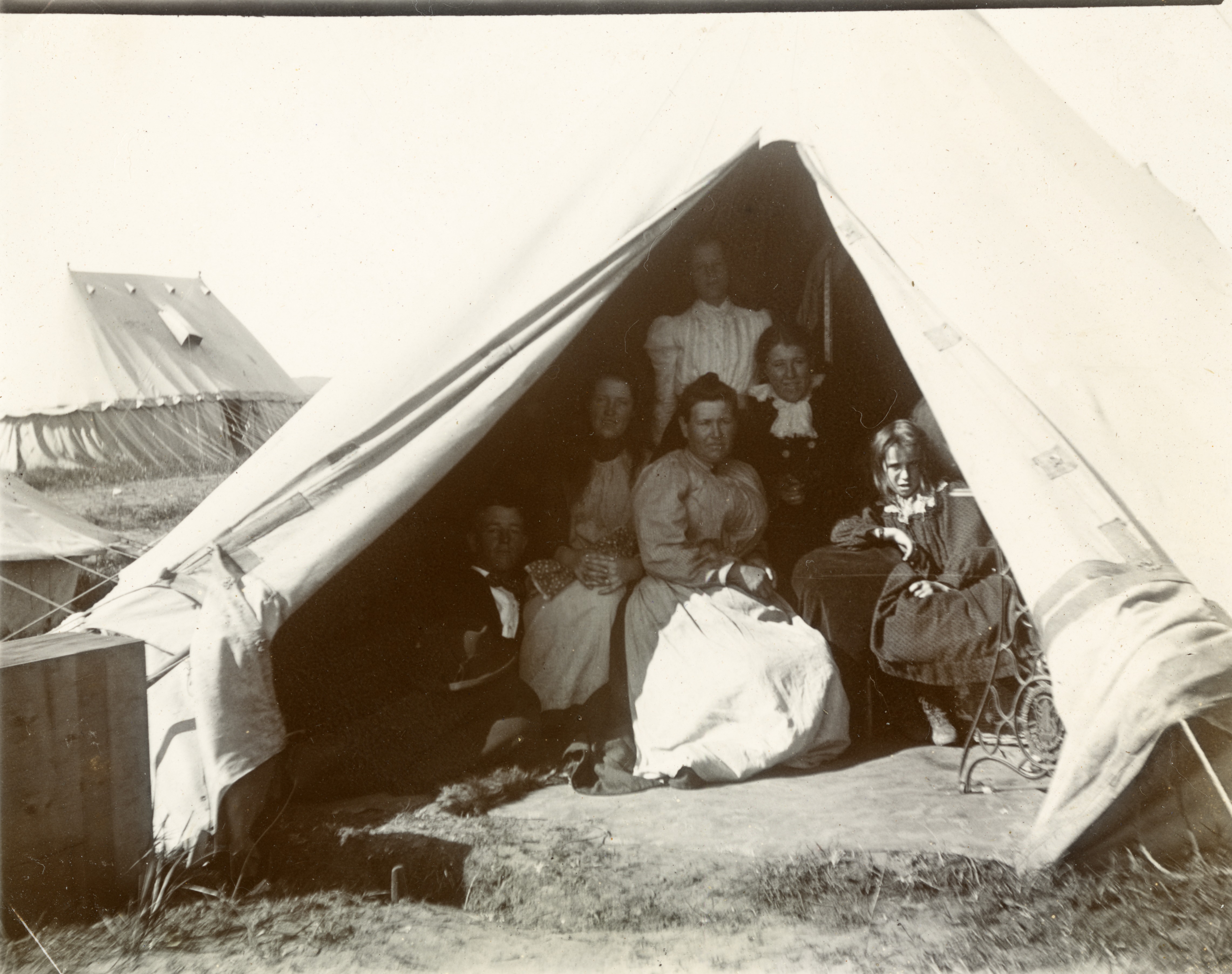 Women and children in a tent, photographed circa 1901. Reproduced at page 34 of the 1902 report on concentration camps in South Africa by the committee chaired by Millicent Garrett Fawcett.