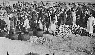 Food distribution at the Al-Magroon concentration camp under Italian colonial rule.