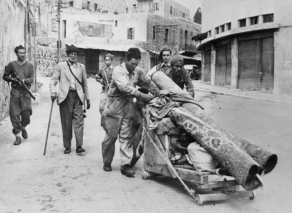 Palestinian residents leaving Haifa under armed Haganah supervision, April 1948.