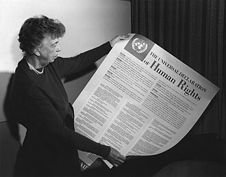 Eleanor Roosevelt holding an English-language declaration poster at Lake Success, New York, in November 1949.